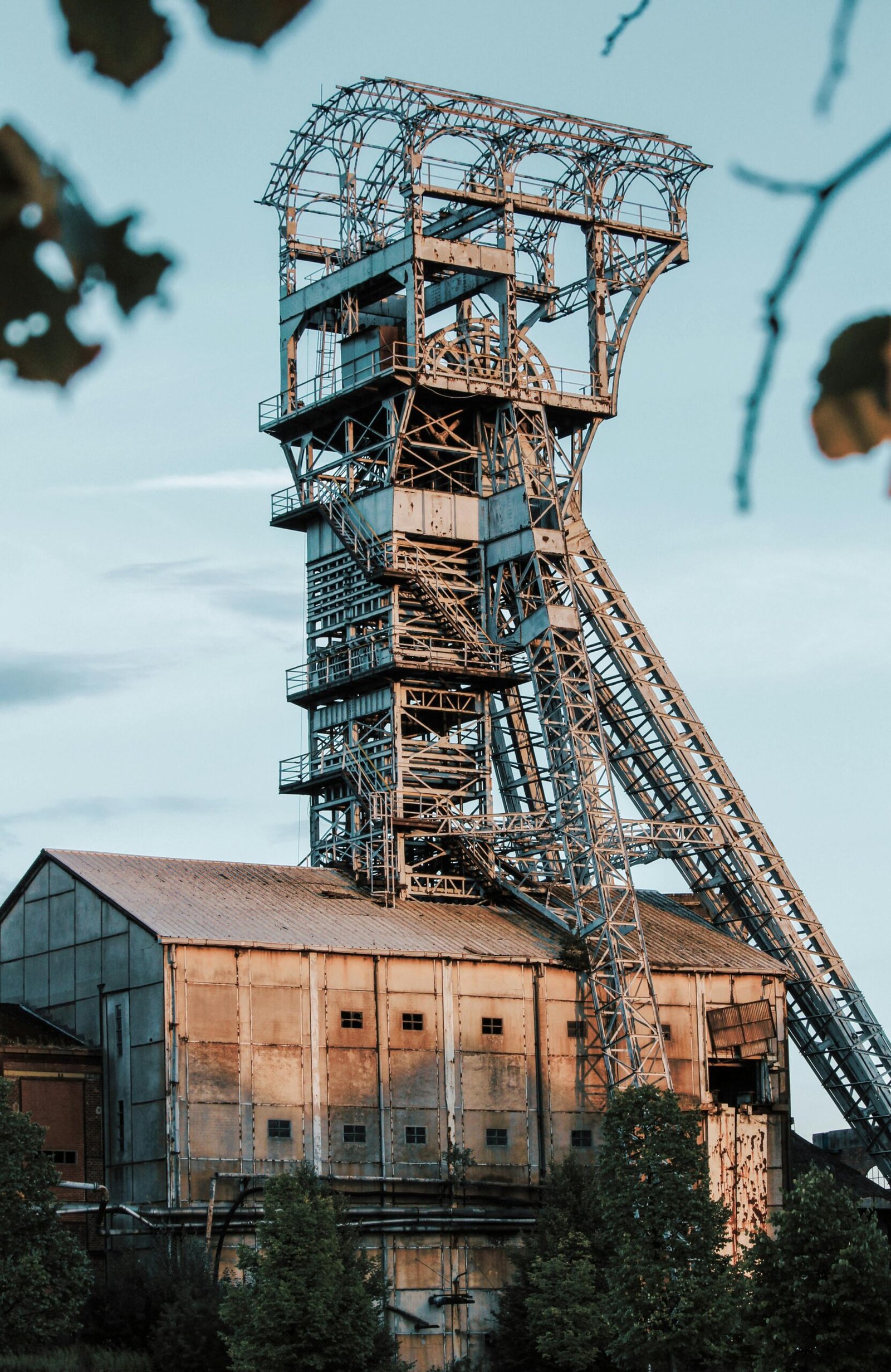 Rusty industrial mining tower in Heusden-Zolder, Belgium during daylight.
